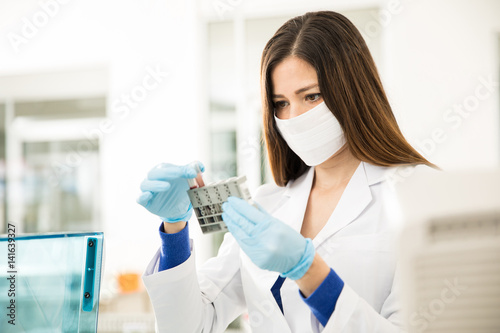 Female chemist analyzing some blood in a laboratory