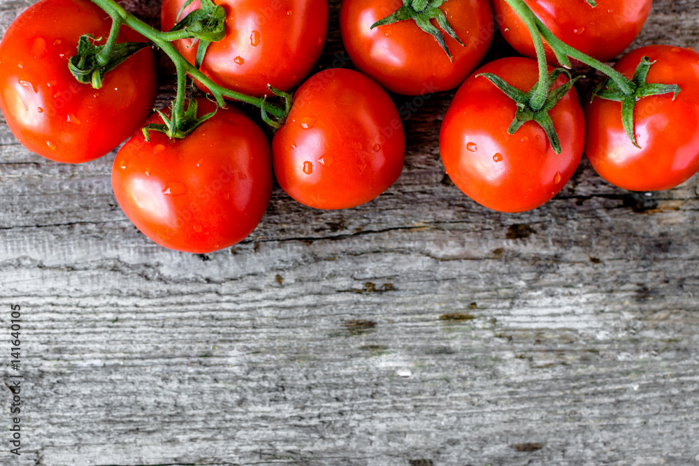 Top view of tomatoes, organic vegetables, fresh produce on wooden background Top view of tomatoes, organic vegetables, fresh produce on wooden background