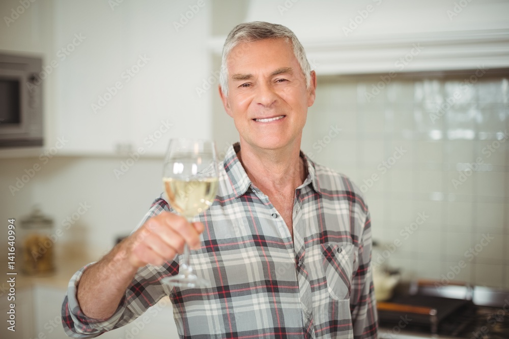 Senior man holding glass of wine