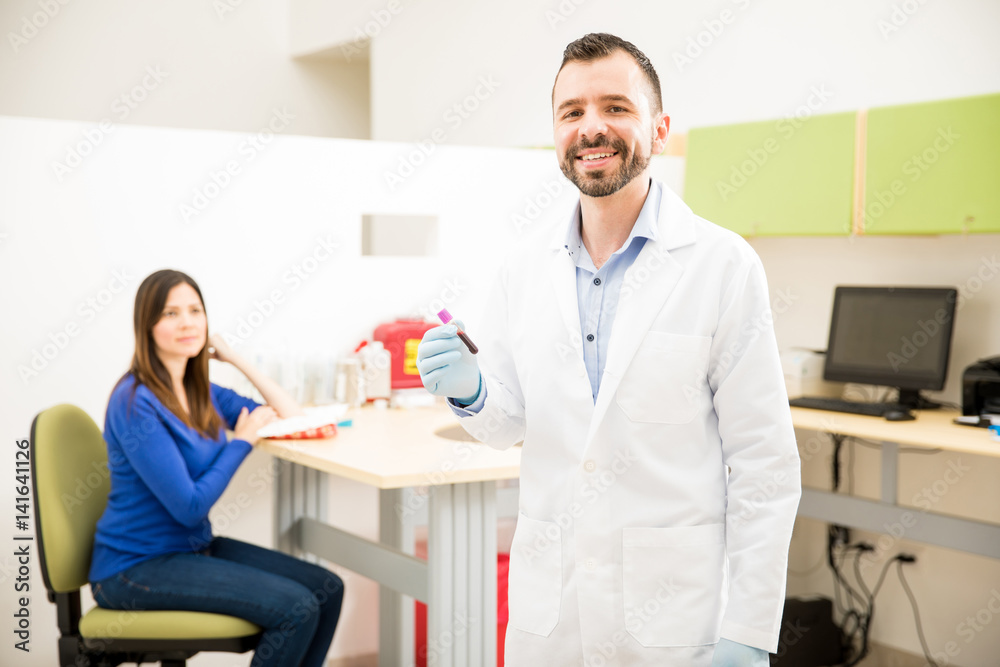 Fototapeta premium Happy doctor with a blood test tube