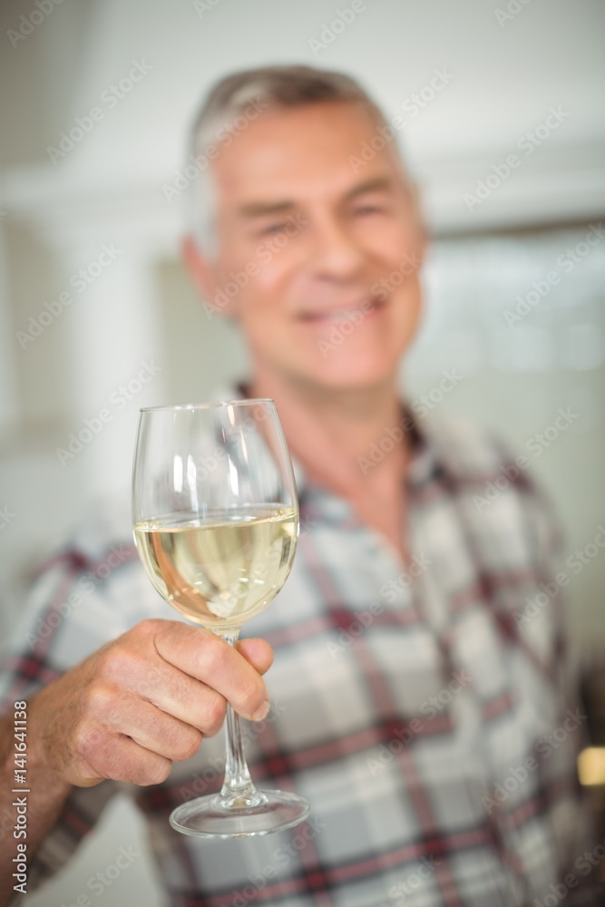 Senior man holding glass of wine