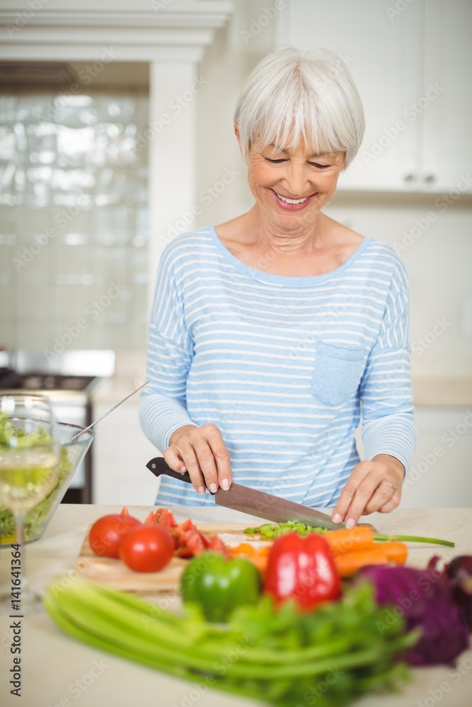 Senior woman cutting vegetable 