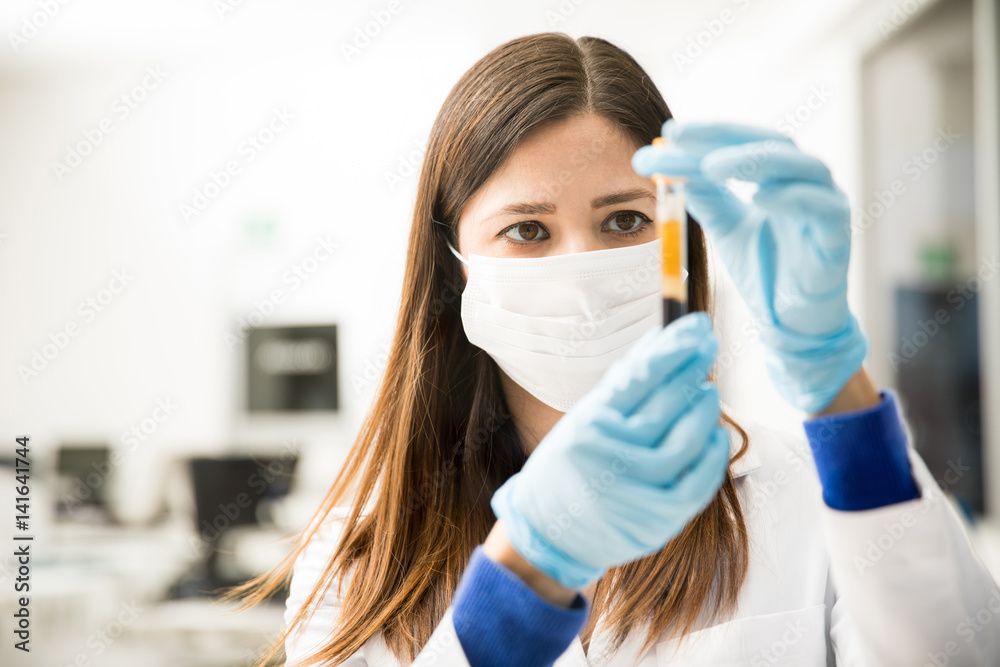 Closeup of chemist looking at a test tube