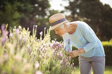 Senior woman smelling flowers