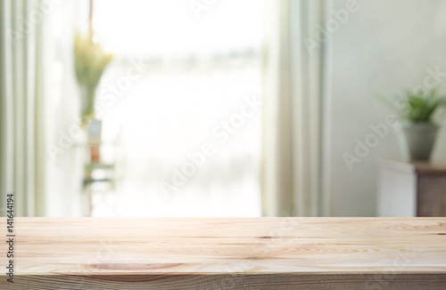 Empty of wood table top on blur of curtain window glass with sunlight background.For montage product display or key visual layout.