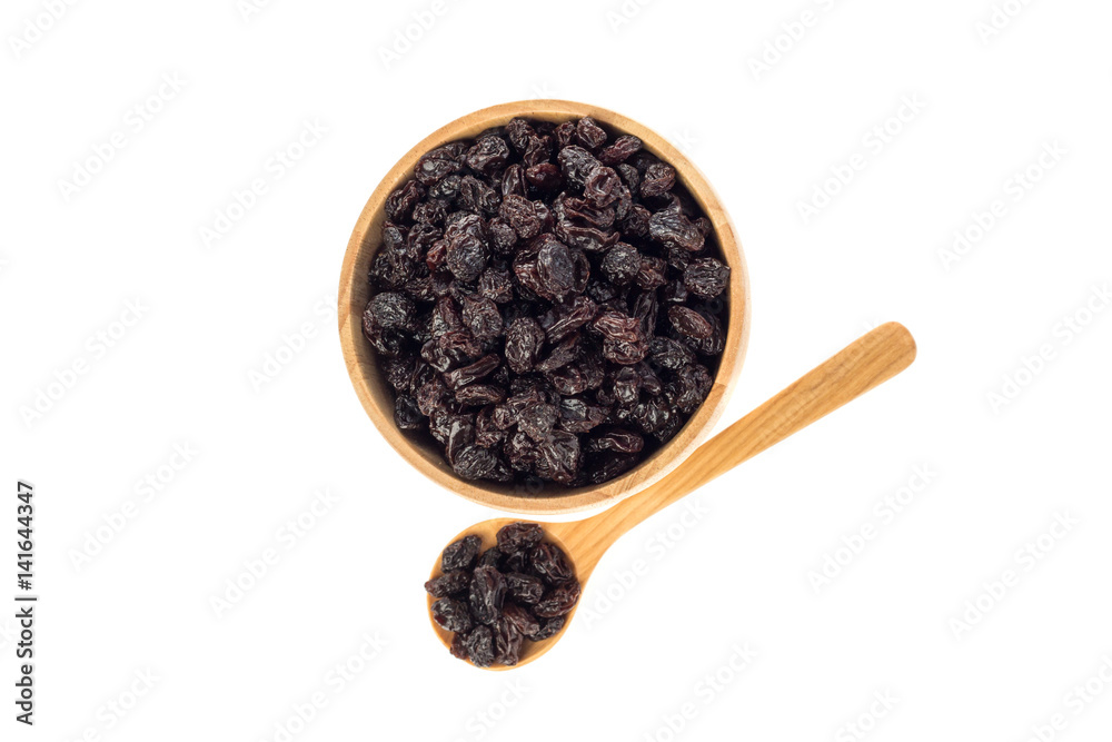 Dried raisins in wooden cup and spoon on white background. Dried raisins in wooden cup and spoon on white background.