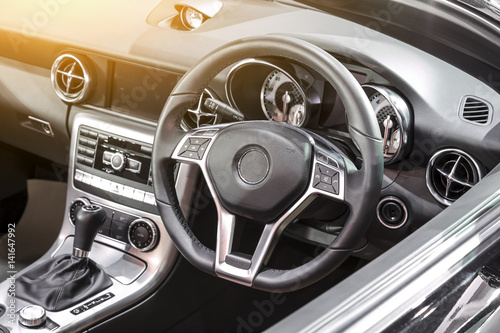 Interior of a modern car, steering wheel and dashboard. © funfunphoto