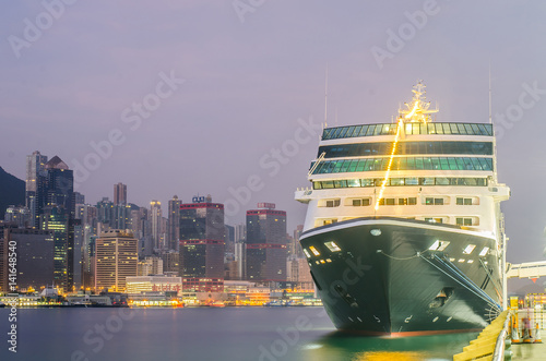 Cruise ship dock embarkment Port Ocean Terminal in Victoria Harbour and Hong Kong Skyline Cityscape at sunrise from Tsim Sha Tsui