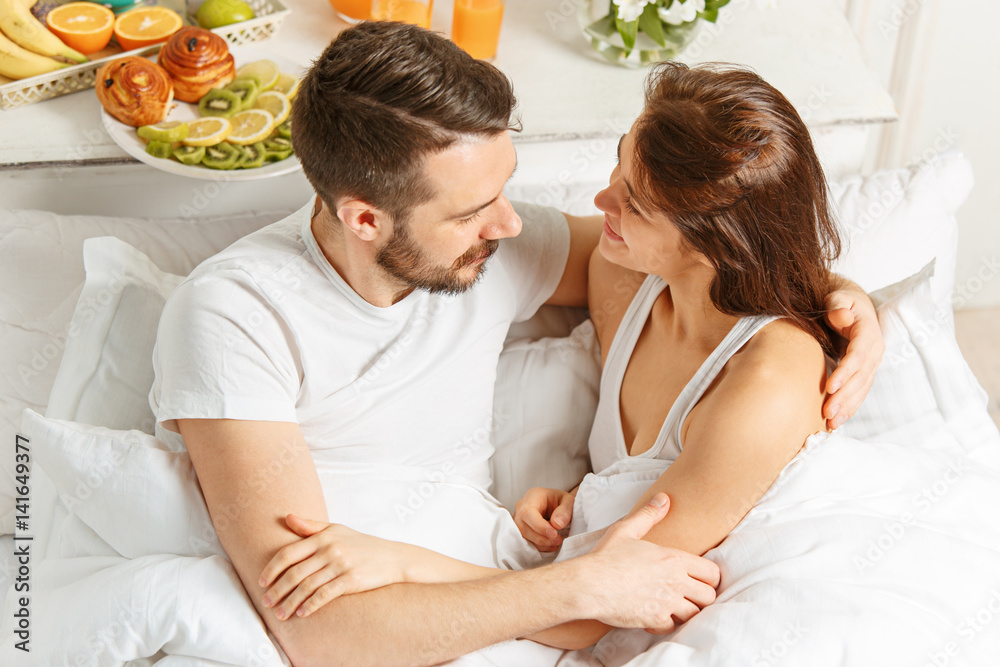 Relaxed Couple in Bed in bedroom at home