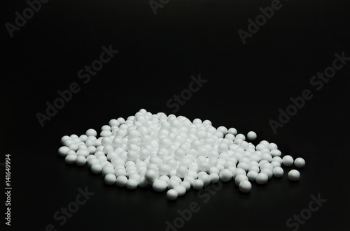 many foam tablets on back background