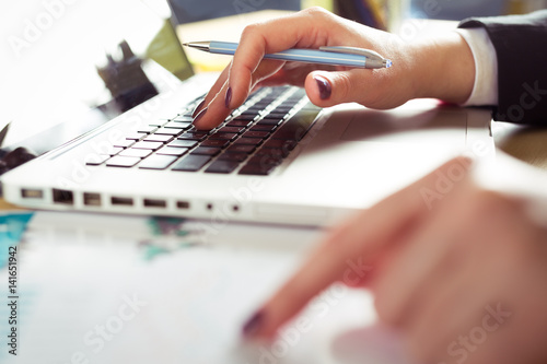 Female hand on a laptop keyboard