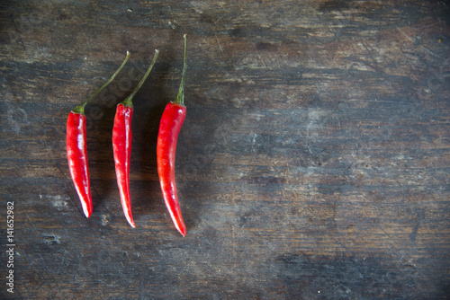 Red hot chilli peppers on the wooden table background