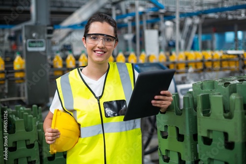 Portrait of smiling female worker using a digital tablet