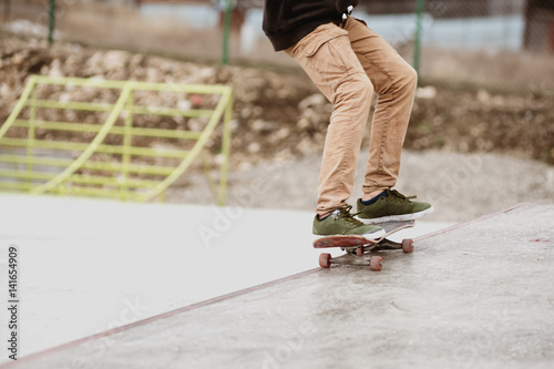 Close-up of skateboarders foot while skating in skate park