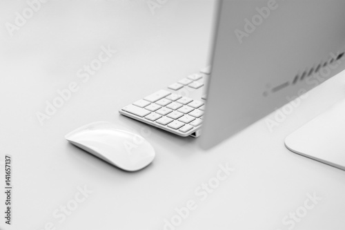 iMac on white clean Office Desk with Magic Mouse