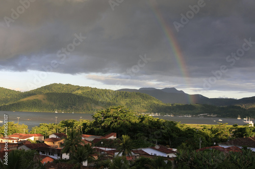 stunning rainbow over tropical rainforest landscape at costa verde, brazil