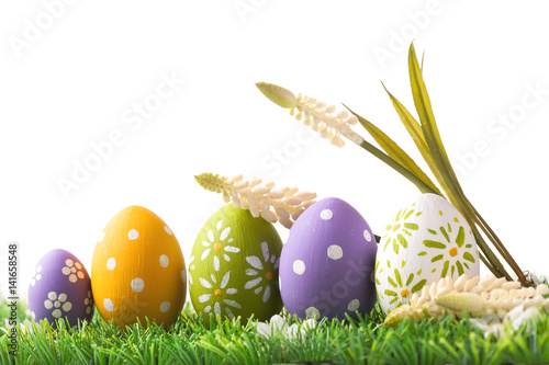 Bunch of easter eggs in pastel colors on grass photo