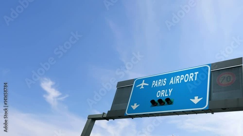plane flying over paris orly airport sign photo