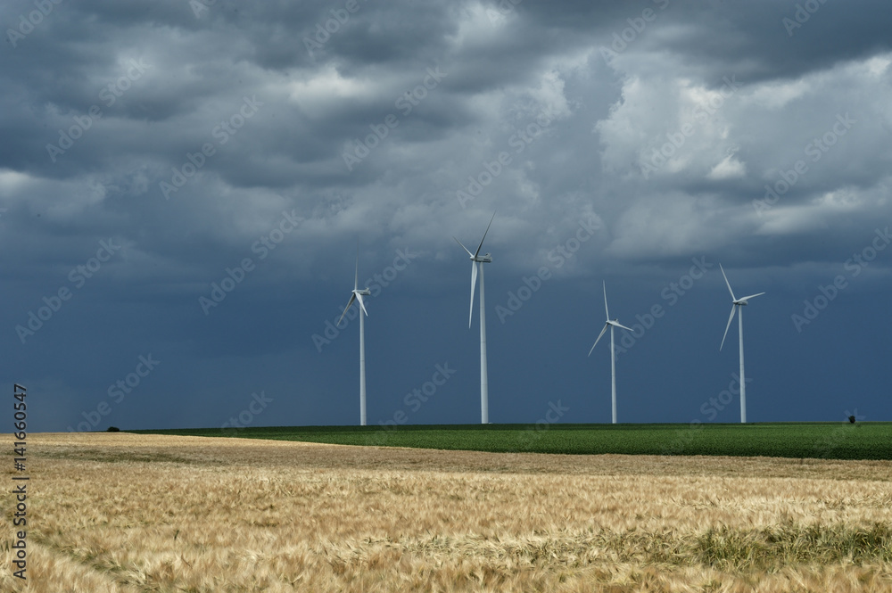 Dark rain clouds on wind power installations.