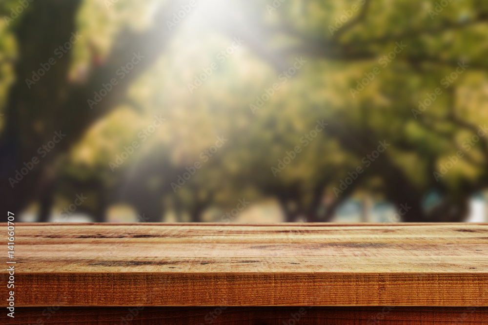 Wooden table and blurred autumn forest background. Wooden table and blurred autumn forest background.