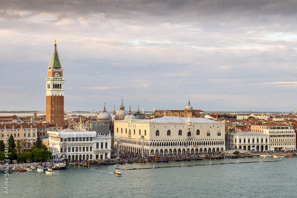 Obraz premium Venetian aerial view from the cruise ship which leaves the port of Venice (Venezia Terminal Passegeri Porto) with St Mark's Campanile bell tower of St Mark's Basilica. Italy.