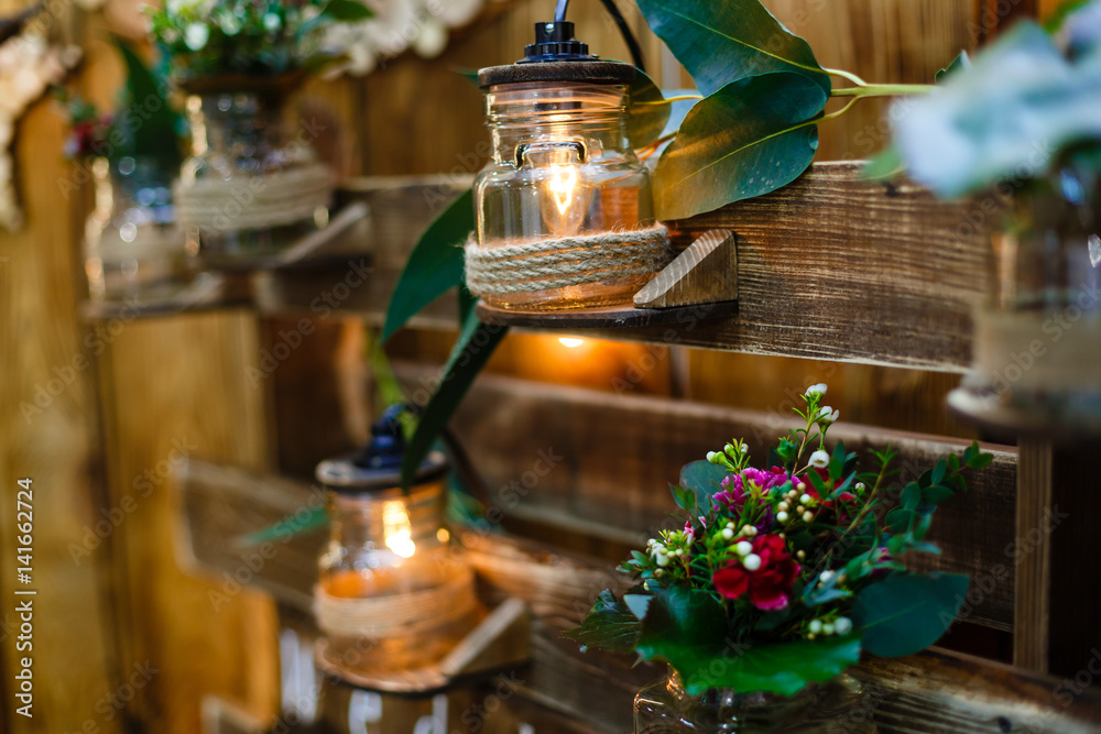 Wedding decor, candles in glass flasks in the forest.