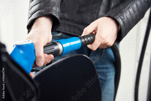 Man refueling petrol tank. Close up.