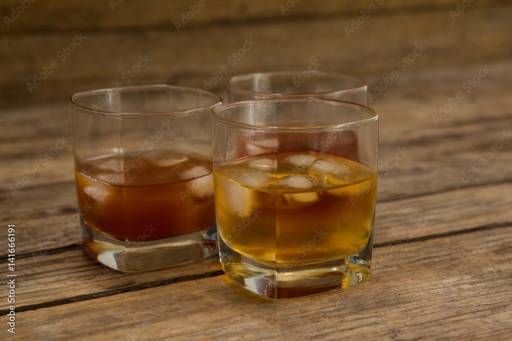 Three glasses of whiskey with ice cube Three glasses of whiskey with ice cube