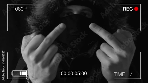 the masked robber shows on a hidden camera the middle finger