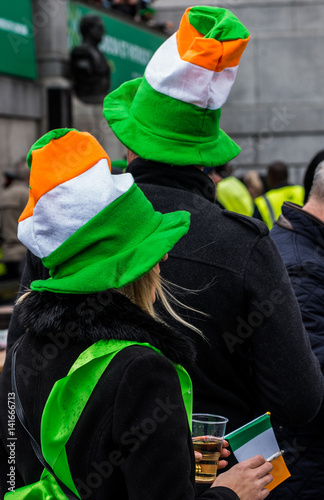 People celebrating St. Patrick day in Trafalgar Square while on stage performing Irish music groups