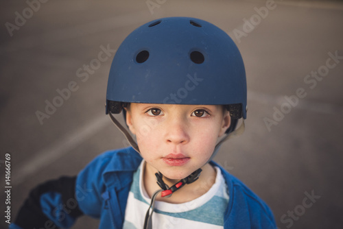 Portrait of cute boy wearing helmet photo