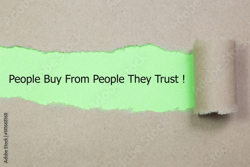Motivational quote People Buy From People They Trust, appearing behind torn paper.