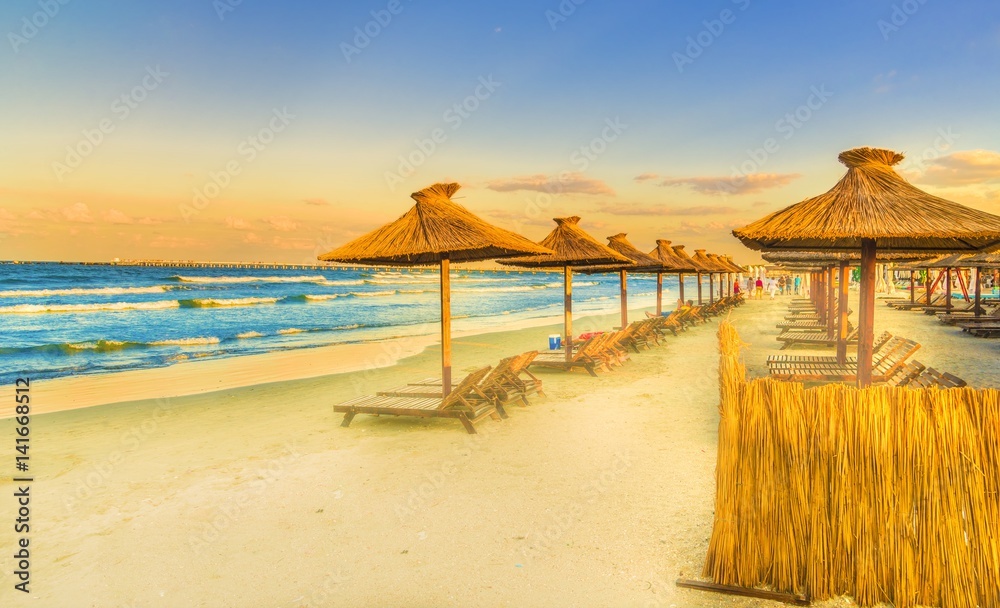 Fototapeta premium Chairs, Black sea and umbrella in Mamaia Holiday Resort, Romania.