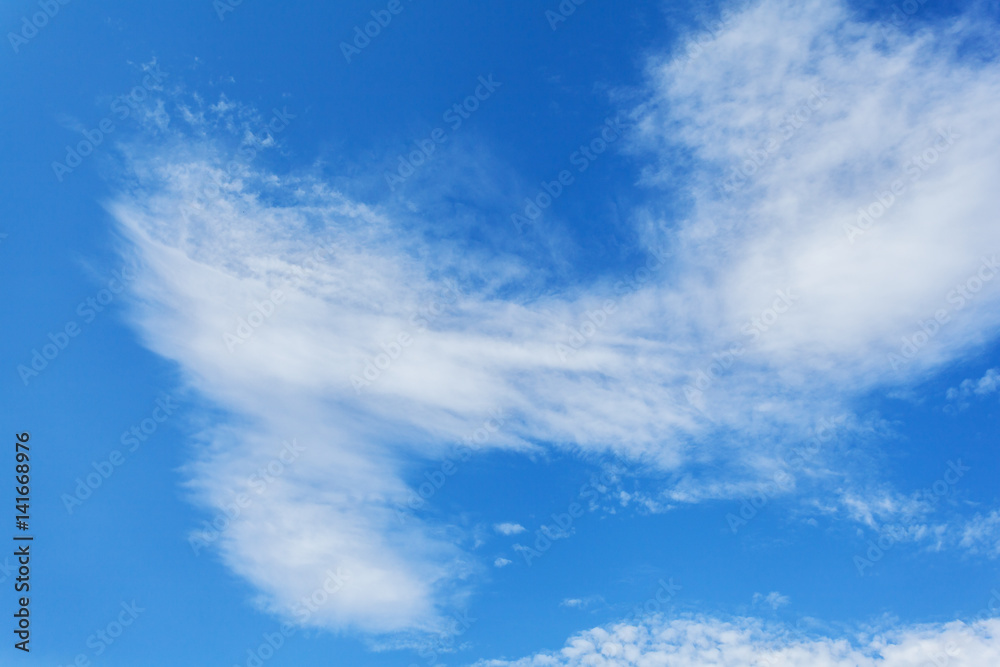 Beautiful white clouds soar across the screen over a deep blue background.