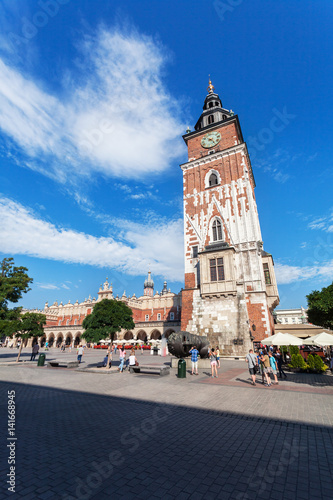 Beautiful high gothic town hall tower with clock in the main Market Square in Cracow, Poland. Travel Europe.
