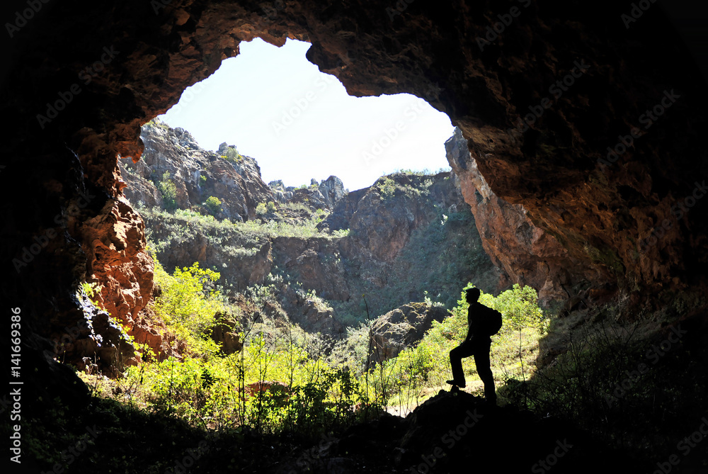 A hiker at the entrance of the mine, Cerro del Hierro, Sierra Norte de Sevilla, Spain