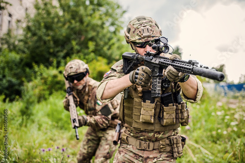 Two military man snipers with airsoft automatic rifle