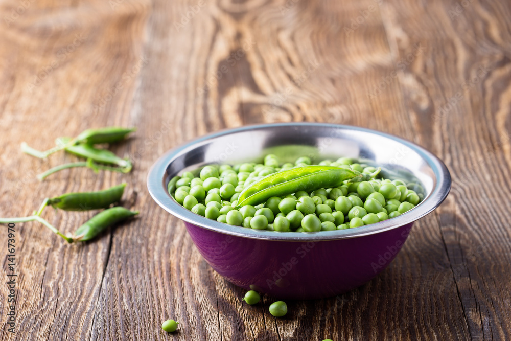Raw organic green peas in bowl Raw organic green peas in bowl