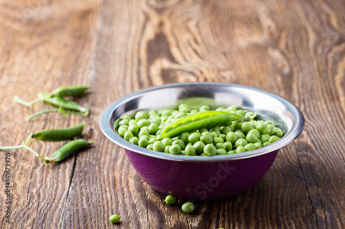 Raw organic green peas in  bowl