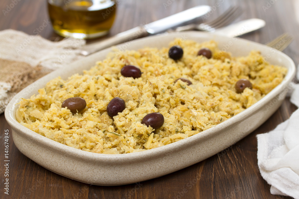 portuguese dish cod fish with potato and eggs on dish