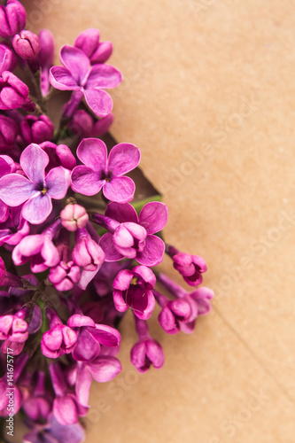 Sprigs of Lilac in postal envelope on wooden background. copy space.spring mood. international women s day. the freshness of flowers.The inscription on the letter -happy. Top view. Flat lay.