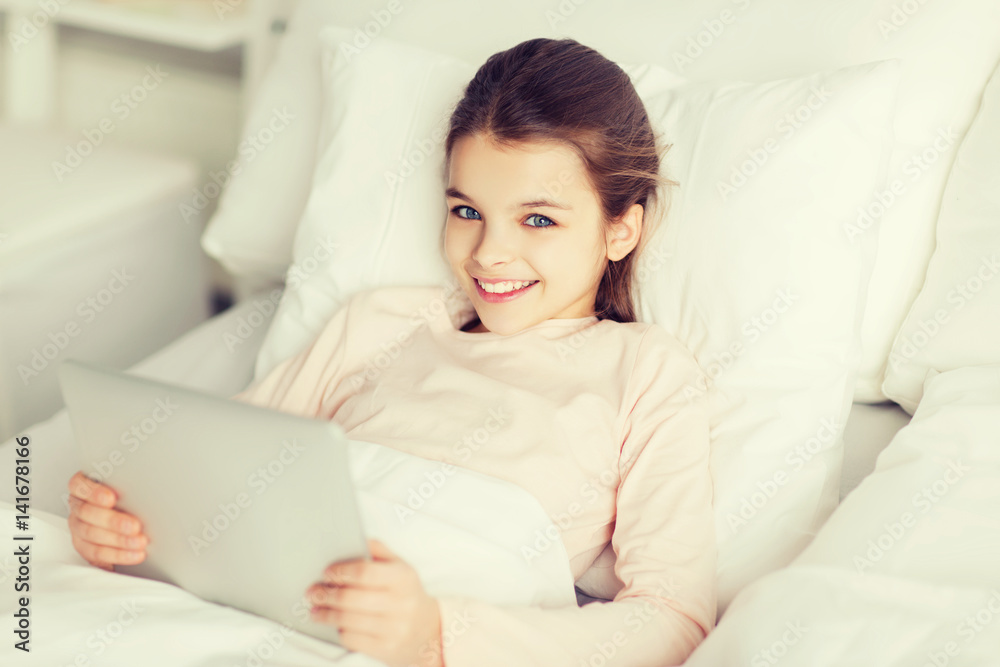happy girl lying in bed with tablet pc at home happy girl lying in bed with tablet pc at home