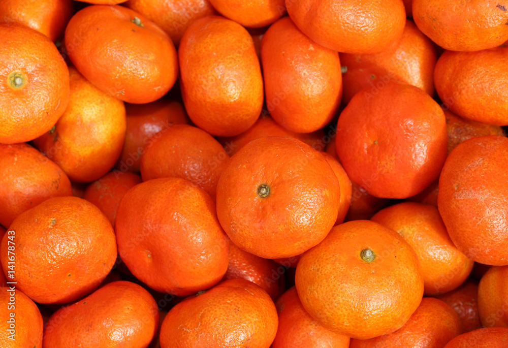 orange background clementines for sale at the greengrocer orange background clementines for sale at the greengrocer