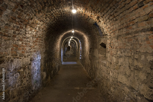 Dark corridor walls under ground with natural lights Budapest Castle Hill © acceptfoto