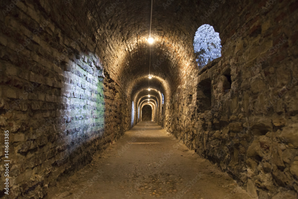 Fototapeta premium Dark corridor walls under ground with natural lights Budapest Castle Hill