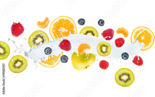 Fruit mix in milk splash, isolated on white background