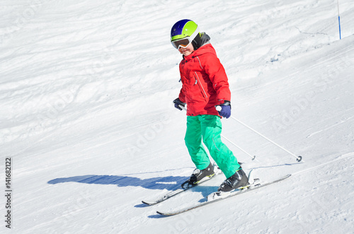Little skier exercising in alpine resort