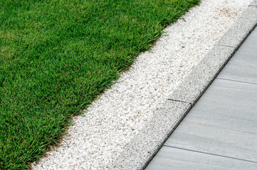Fototapete Grün gravel in landscape design is poured near the lawn  © Andrey