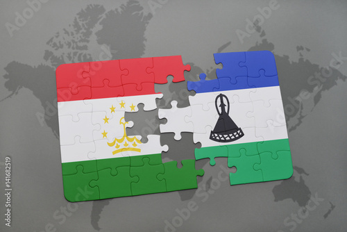 puzzle with the national flag of tajikistan and lesotho on a world map