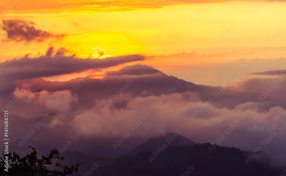 foggy orange sunset in the mountains in Colombia